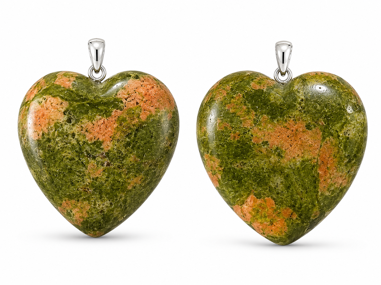Two heart-shaped pendant charms made of green and orange mottled stone, each with a silver bail, shown side by side on a white background.