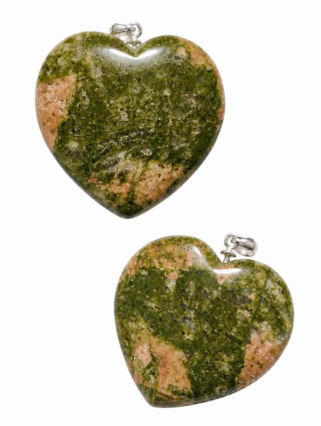 Two heart-shaped green and tan stone pendants with silver bail loops, shown on a plain white background.