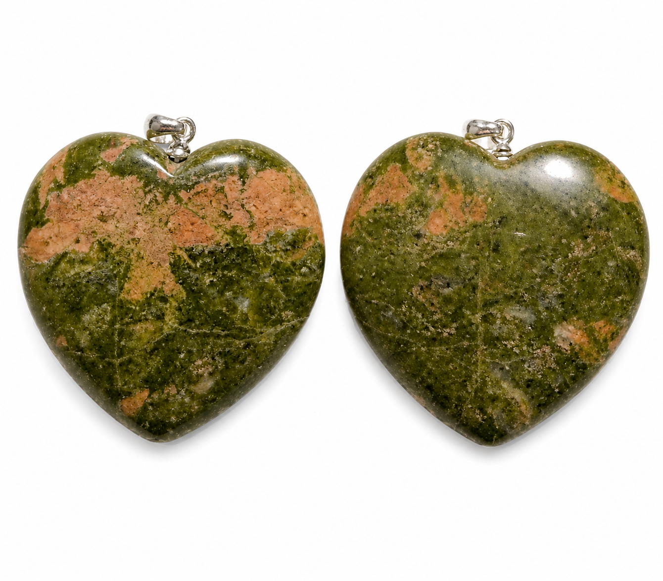 Two heart-shaped green stone pendants with natural orange-brown marbling and silver bail loops, displayed side-by-side on a white background.