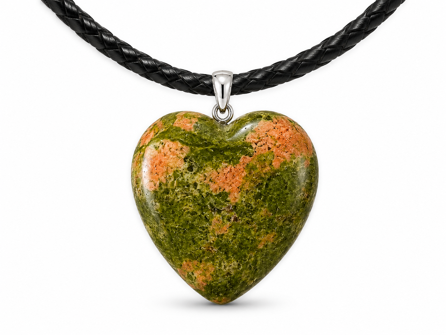 A heart-shaped polished stone pendant with a green and orange mottled pattern, suspended from a black braided cord necklace on a white background.